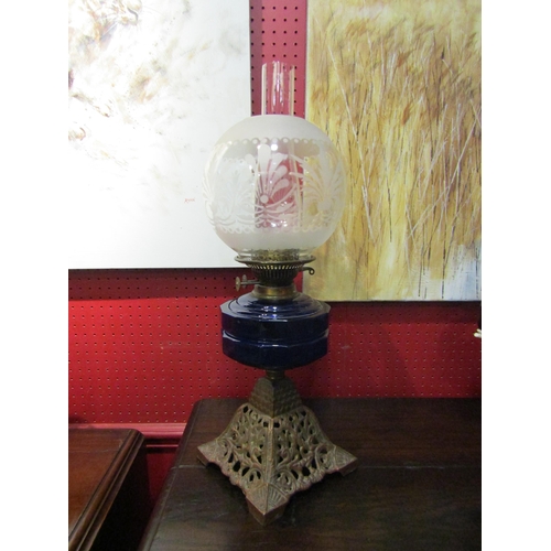 4027 - A Victorian oil lamp with Bristol blue glass reservoir and pierced cast metal base