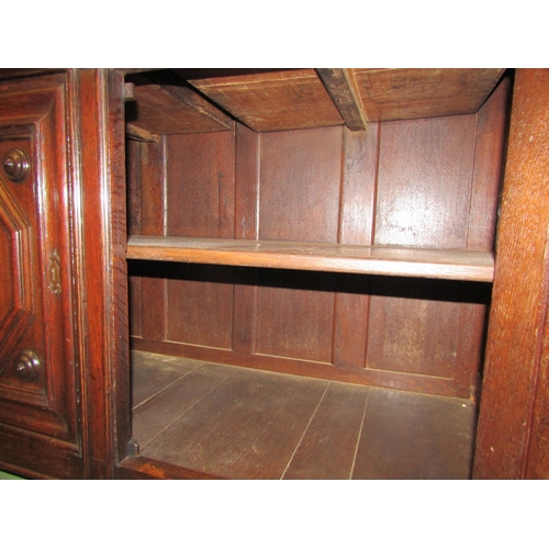 4030 - A 19th Century French pegged oak dresser base, the two drawers over a two door cupboard on stile fee... 