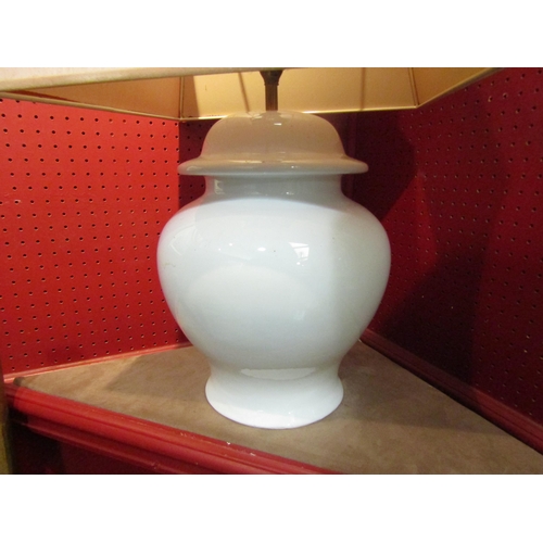 4048 - A white bulbous form table lamp of Chinese influence with a pale pink silk shade