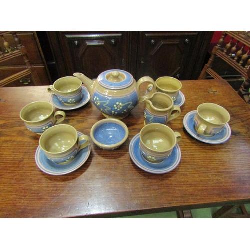 4061 - An Aysgarth Pottery, N. Yorks Studio pottery tea set, beige ground, blue panels, slip flower teapot,... 