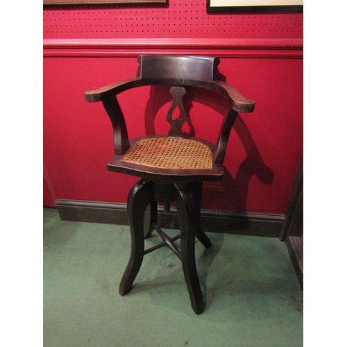 4078 - A Victorian mahogany child's revolving height adjustable high chair with cane seat    (R) £45