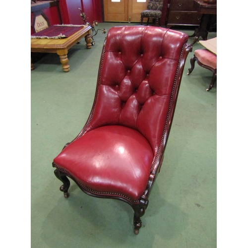 4091 - A circa 1860 mahogany and red leather button-back armchair with carved decoration, the serpentine fr... 