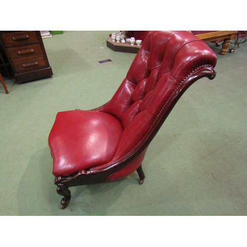 4091 - A circa 1860 mahogany and red leather button-back armchair with carved decoration, the serpentine fr... 