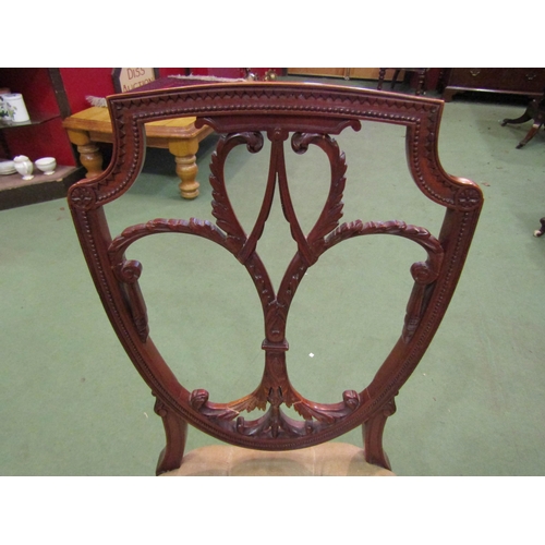 4092 - A Regency style carved walnut shield back chair, the button upholstered seat over spade foot square ... 