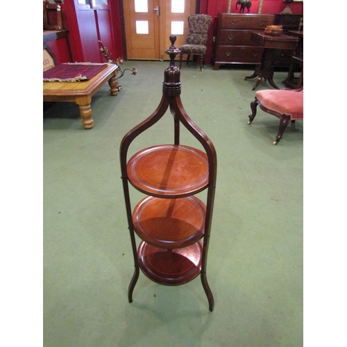 4104 - An Edwardian line inlaid mahogany three tier cake stand in the manner of 