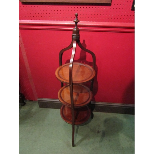 4104 - An Edwardian line inlaid mahogany three tier cake stand in the manner of 