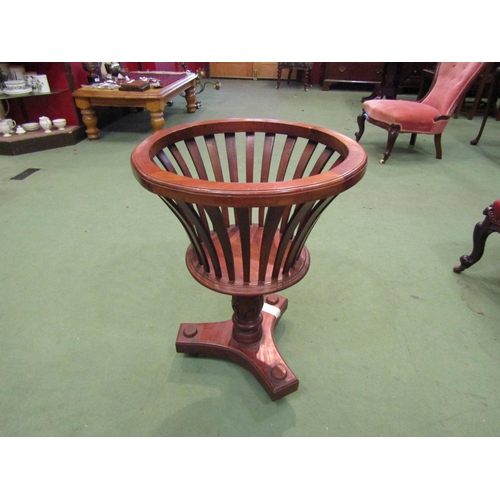 4114 - A mahogany pierced planter on turned column and tri-footed base, 65cm tall x 49cm diameter