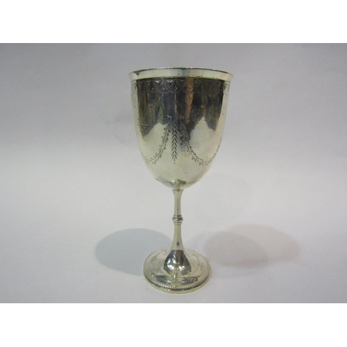 4298 - A Victorian silver goblet with engraved floral swag decoration, London 1873, maker rubbed with engra... 