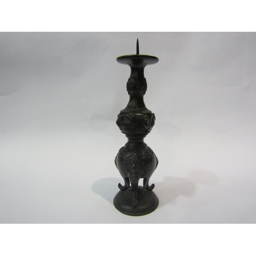 4299 - A vintage Indian bronze candlestick with tiger heads, 24cm total height