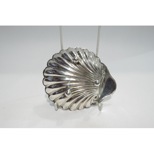 4362 - A silver shell shaped  butter dish on three ball feet, length approximately 5