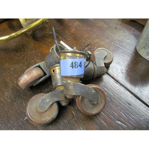 2075 - A set of four Victorian brass and brown porcelain castors and three small brass castors