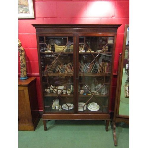 4128 - A Georgian flame mahogany astragal glazed two door bookcase with height adjustable shelves and key o... 