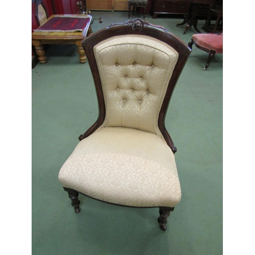 4155 - A walnut mid Victorian button-back armchair with carved relief, the bow front seat over turned and t... 