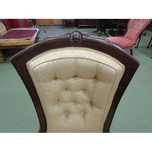 4155 - A walnut mid Victorian button-back armchair with carved relief, the bow front seat over turned and t... 