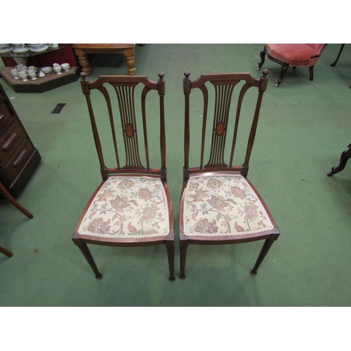 4162 - A pair of Edwardian Arts & Crafts inlaid mahogany chairs with finial decoration over a pierced and i... 