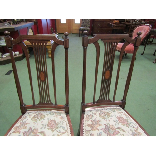 4162 - A pair of Edwardian Arts & Crafts inlaid mahogany chairs with finial decoration over a pierced and i... 