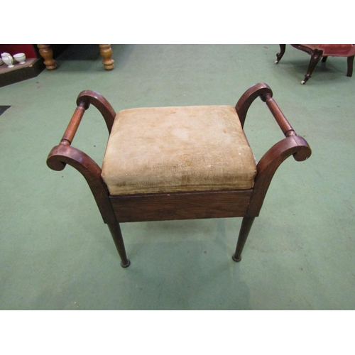 4166 - An oak piano stool with turned handles on pad feet