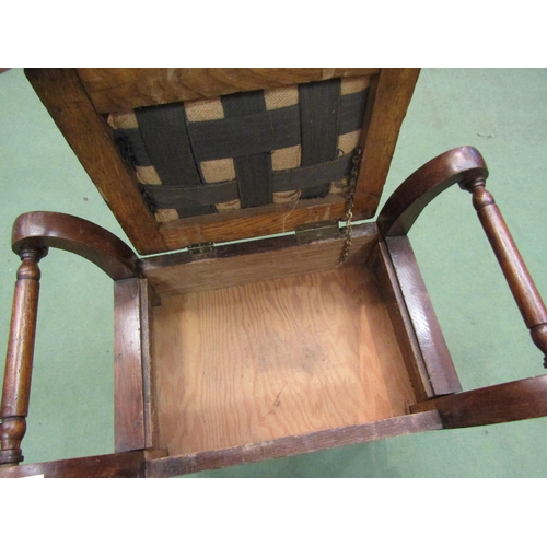 4166 - An oak piano stool with turned handles on pad feet