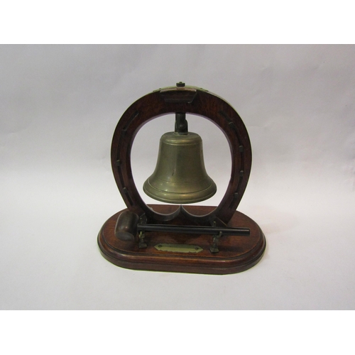 4173 - A brass bell with beater on oak stand, 28cm tall x 32cm long