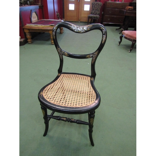 4195 - A Victorian black lacquered and mother-of-pearl inlaid chair, the kidney shape backrest over a cane ... 