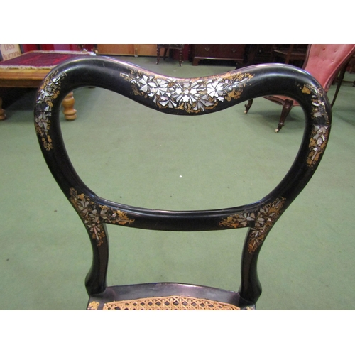 4195 - A Victorian black lacquered and mother-of-pearl inlaid chair, the kidney shape backrest over a cane ... 