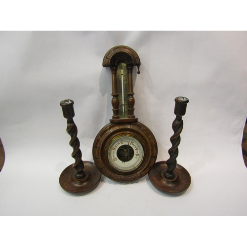 4201 - A wall barometer / thermometer (missing finial) together a pair of oak barley twist candlesticks (3)... 