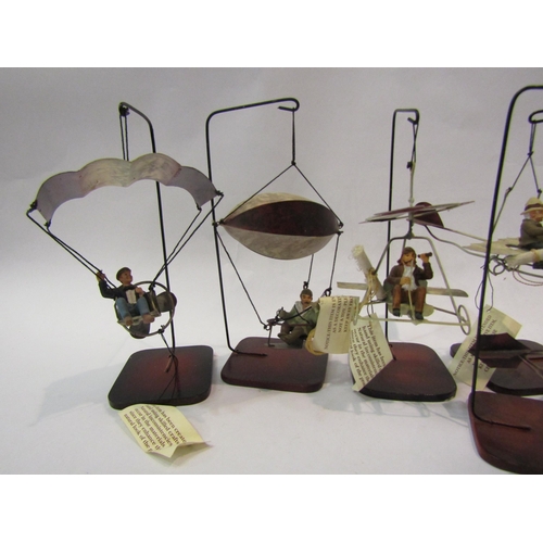 4204 - Six hanging metal models of Heath Robinson style aircraft, on stands