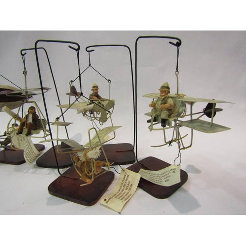 4204 - Six hanging metal models of Heath Robinson style aircraft, on stands