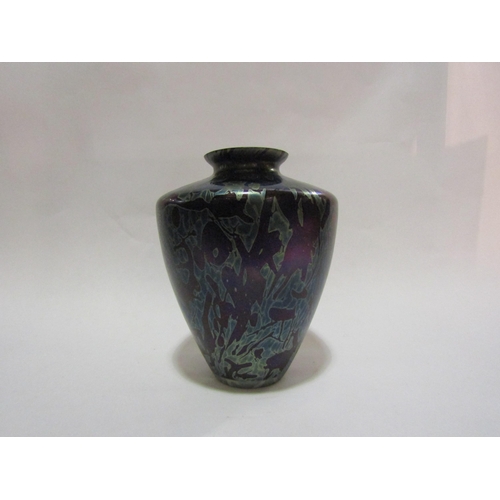 4242 - A Liberty style iridescent glass vase, 21cm tall