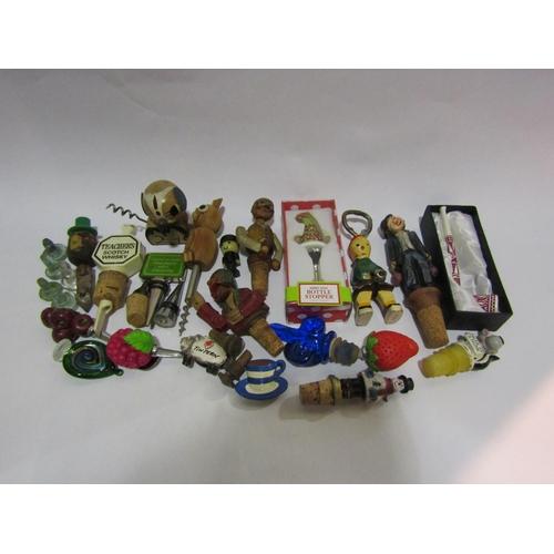 4277 - A collection of bottle openers and bottle stoppers including figural example