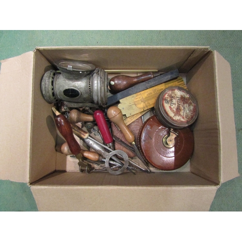 4285 - A box of mixed collectables including leather cased measuring tape, Rabone rules and bicycle lamp et... 