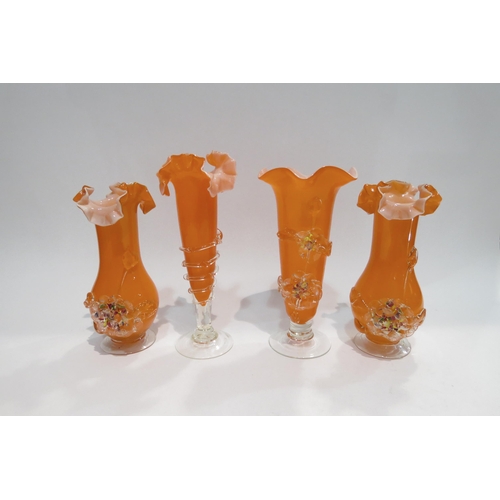 4418 - A set of three orange Art glass vases with coloured applied floral design together with a similar ex... 