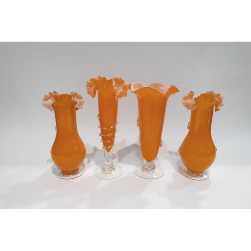 4418 - A set of three orange Art glass vases with coloured applied floral design together with a similar ex... 