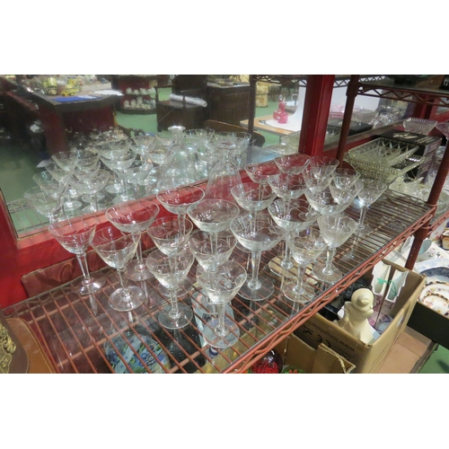 4438 - A floral decorated etched glass decanter with matching champagne saucers and wine glasses (24)