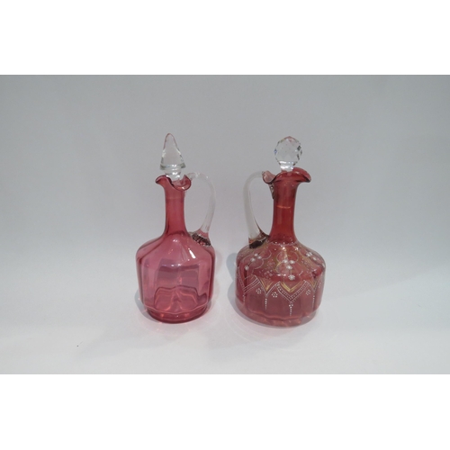 4439 - Two Cranberry glass decanters with stoppers including example with gilt applied detail