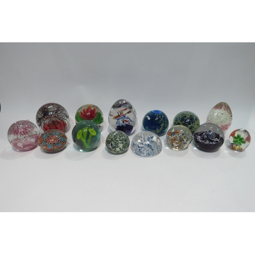 4441 - A collection of glass paperweights to include Mdina and Millefiori examples, together with two books... 