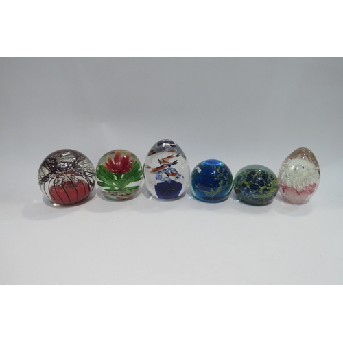 4441 - A collection of glass paperweights to include Mdina and Millefiori examples, together with two books... 