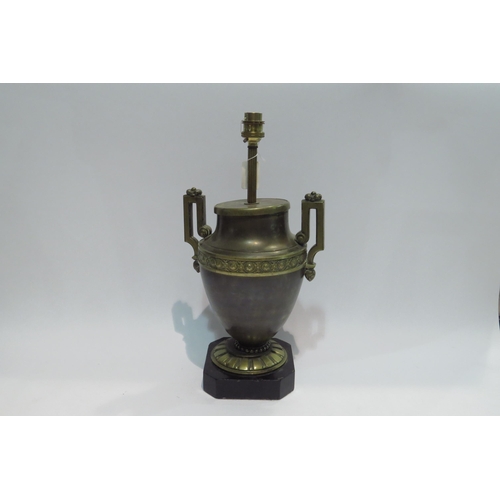 4447 - A brass urn form twin handled lamp on glass form plinth, 37cm tall     (E) £15-20