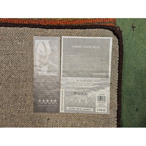 4463 - A John Lewis hand made multi-coloured, rich stripe design rug, 240cm x 170cm (a/f with large stain t... 