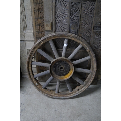 2115 - A wooden cart wheel iron rim 60cms diameter