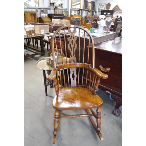 2218 - An 18th Century reproduction elm seated Windsor rocking chair, hoop-back with pierced central splat