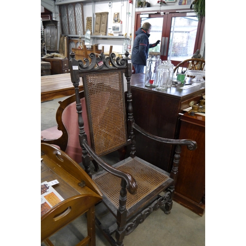 2224 - A Charles II style oak and cane chair