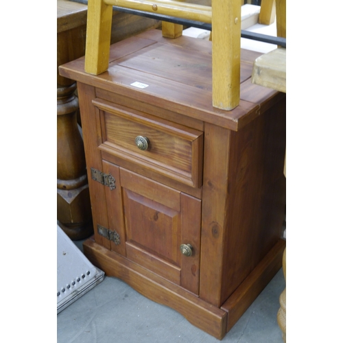 2284 - A pine bedside cabinet, single drawer over single door plinth base