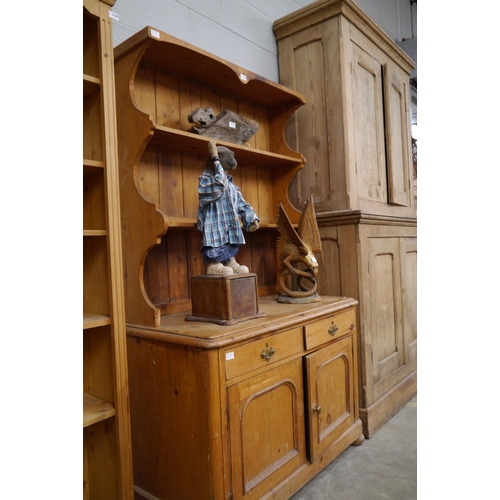 2330 - A turn of the 20th Century pine dresser with shaped plate rack top over two drawer two cupboard door... 