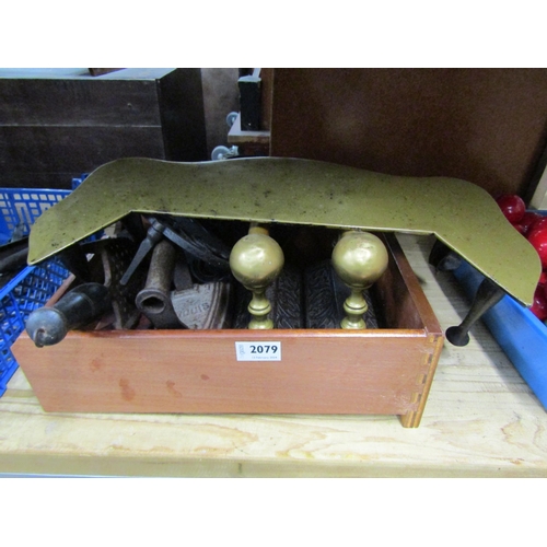 2079 - A box of cast iron trivets, irons, cast iron and brass footman etc     (R) £20