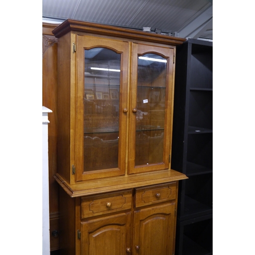 2345 - A modern beech dresser, two door glazed over a two drawer and two door cupboard base