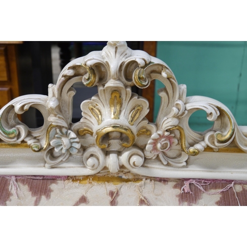 2350 - An ornately painted and gilt sofa frame for re-holstery