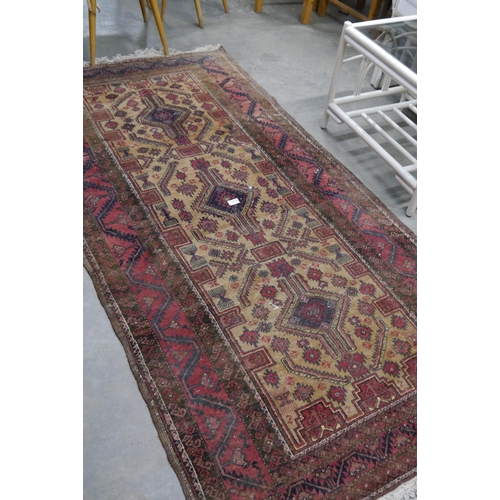 2428 - A brown and red rug 208cm x 106cm