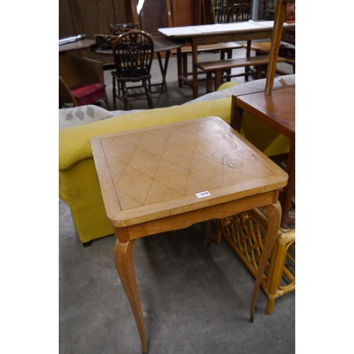 2446 - A mid Century French geometric inlaid occasional table, legs finished with brass caps