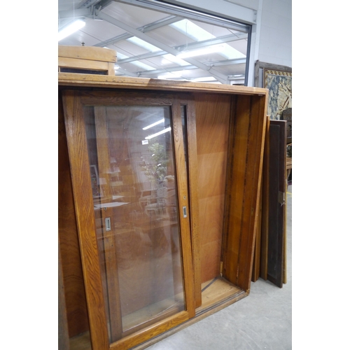 2455 - A Victorian oak and glazed two door bookcase with shelved interior